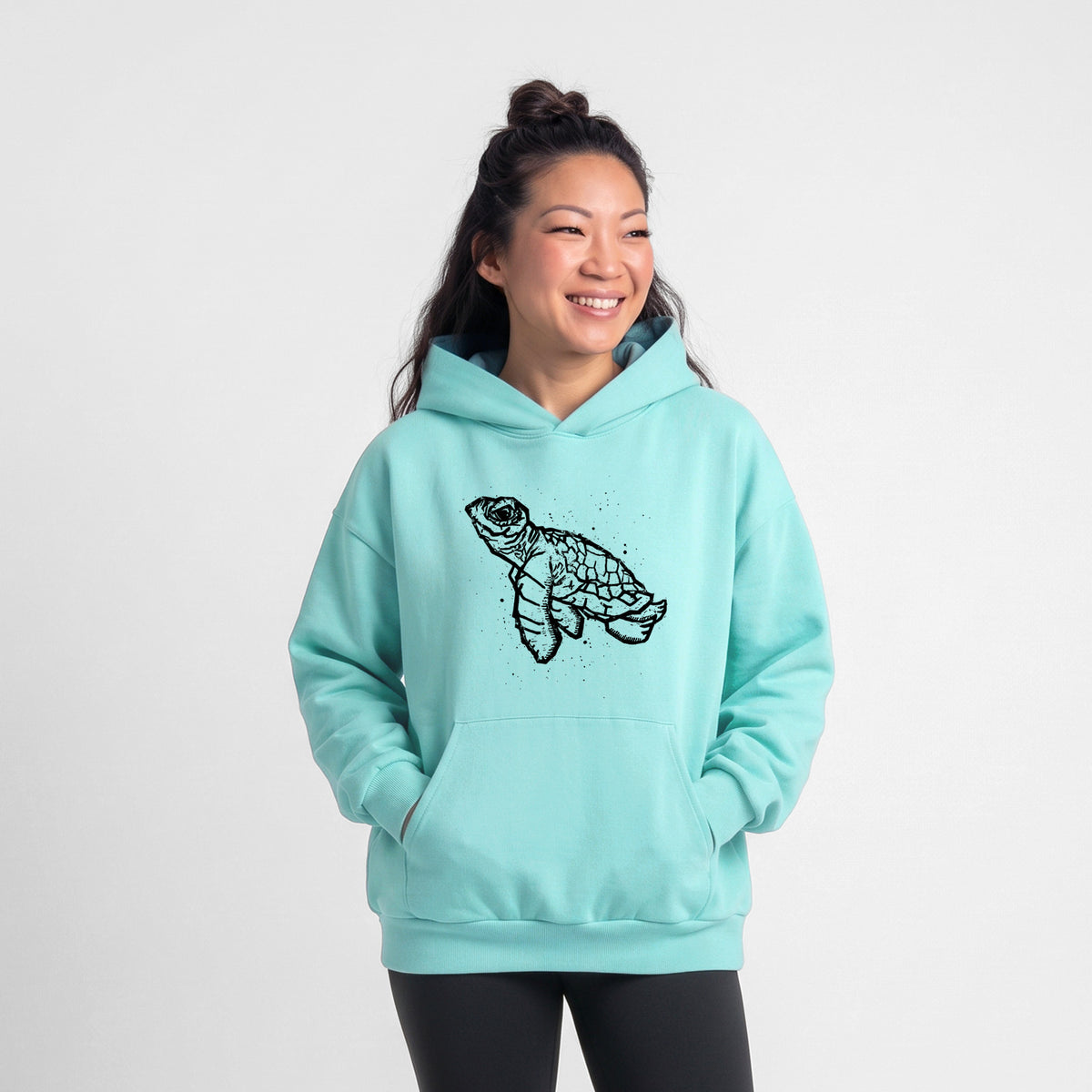 Female model wearing the Baby Sea Turtle - Statement Midweight Hoodie.