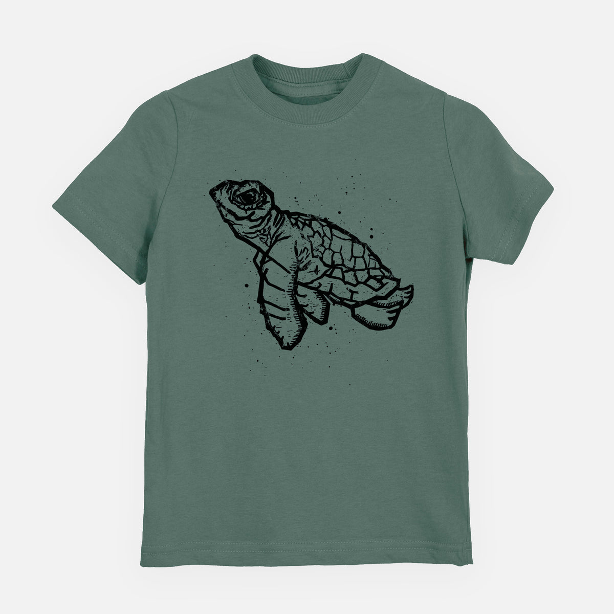 Basil green youth t-shirt laid flat, printed with a black linocut-style illustration of a baby sea turtle with a patterned shell and ink splatters.