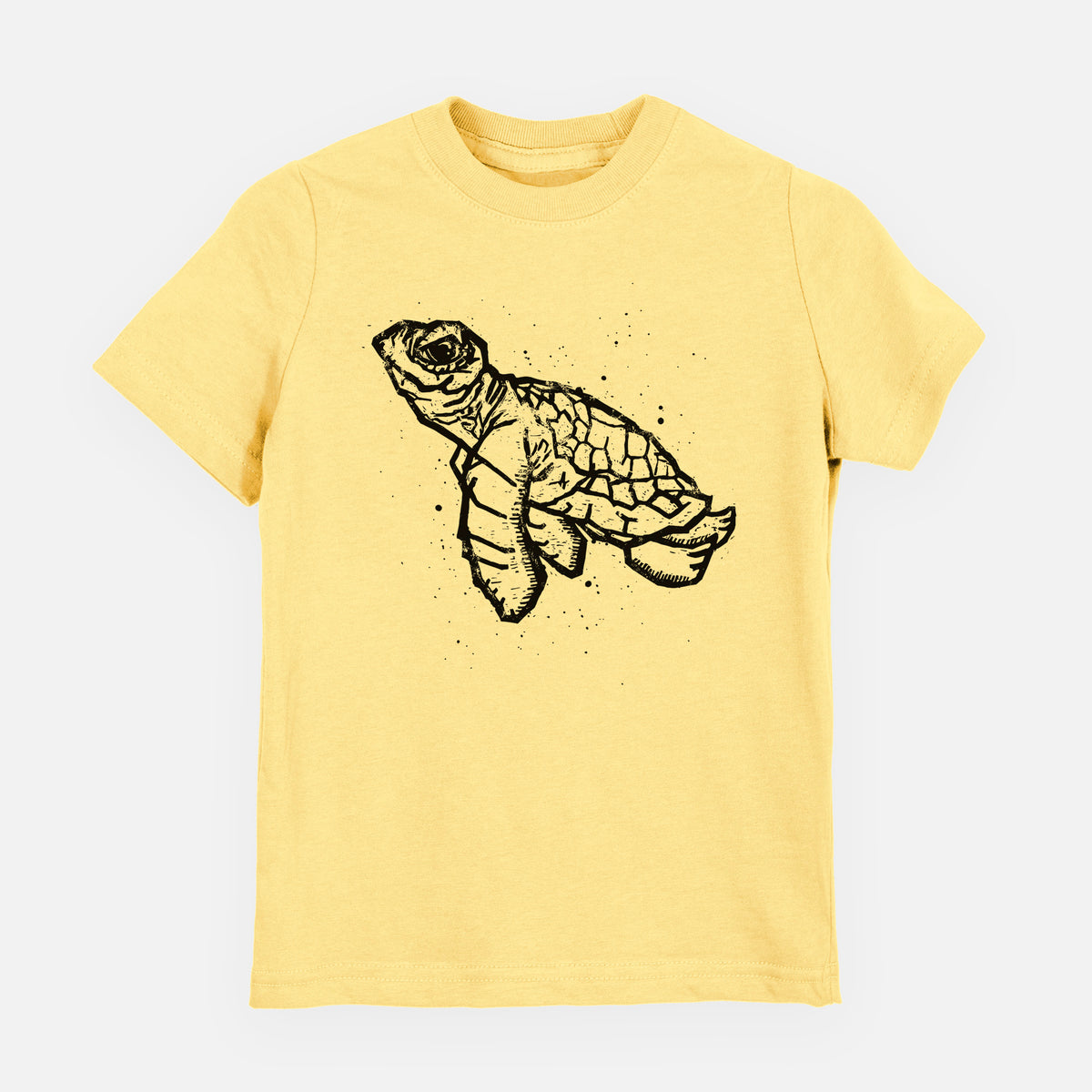 Butter yellow youth t-shirt laid flat, printed with a black linocut-style illustration of a baby sea turtle with a patterned shell and ink splatters.
