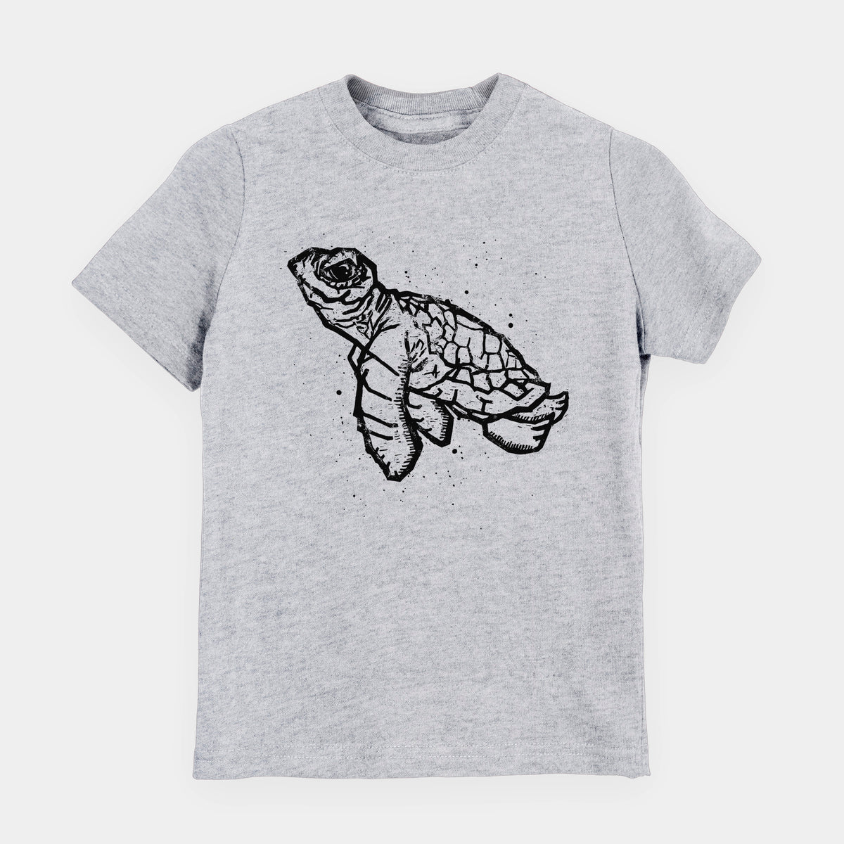Heather grey youth t-shirt laid flat, printed with a black linocut-style illustration of a baby sea turtle with a patterned shell and ink splatters.