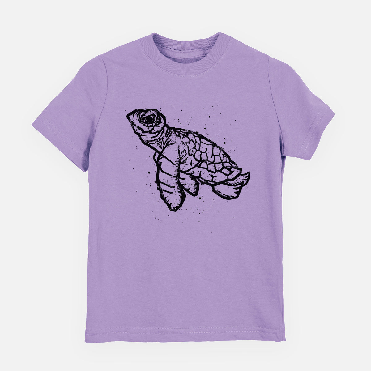 Lavender youth t-shirt laid flat, printed with a black linocut-style illustration of a baby sea turtle with a patterned shell and ink splatters.