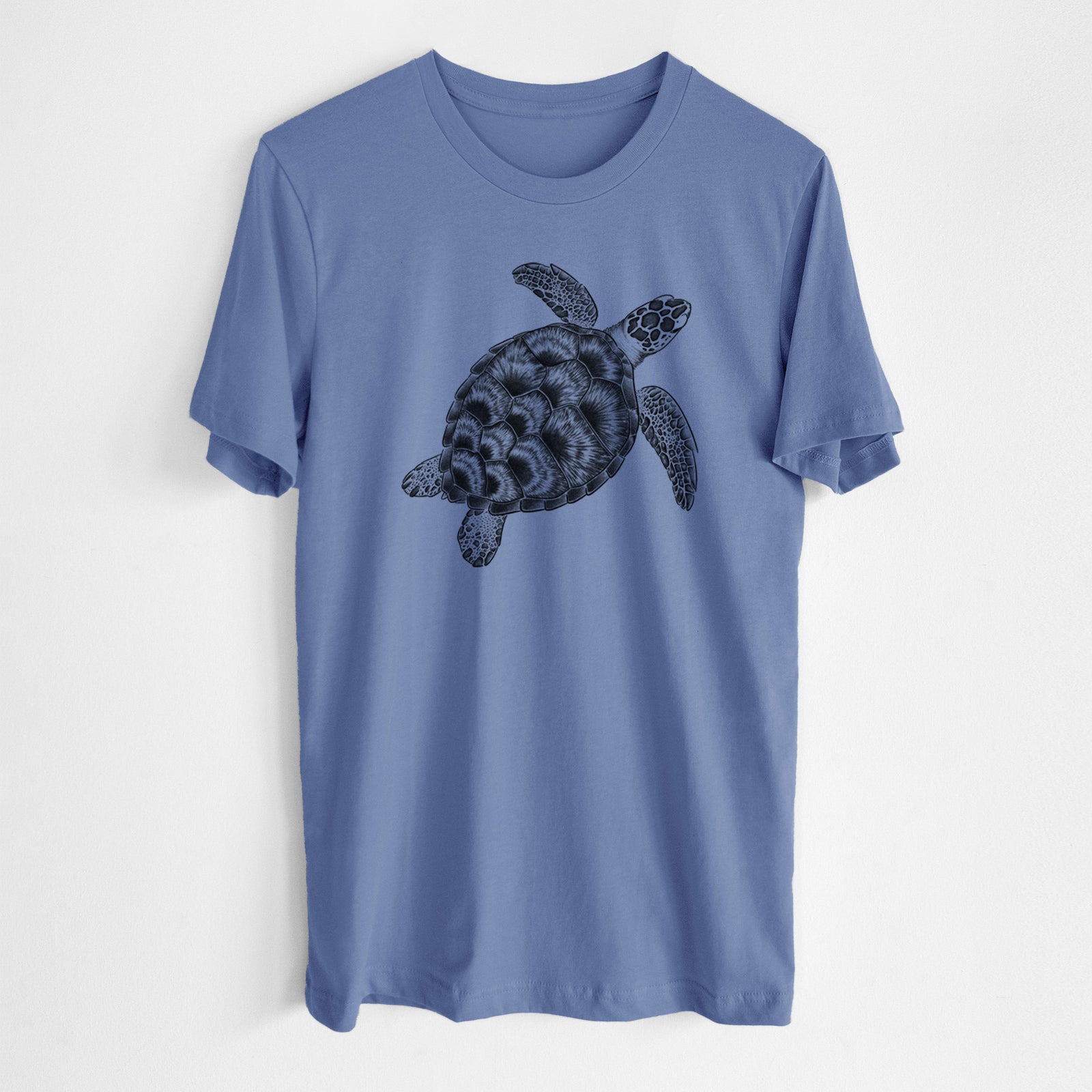 Blue bell lightweight cotton t-shirt laid flat, printed with a detailed black ink illustration of a loggerhead sea turtle swimming, seen from above.