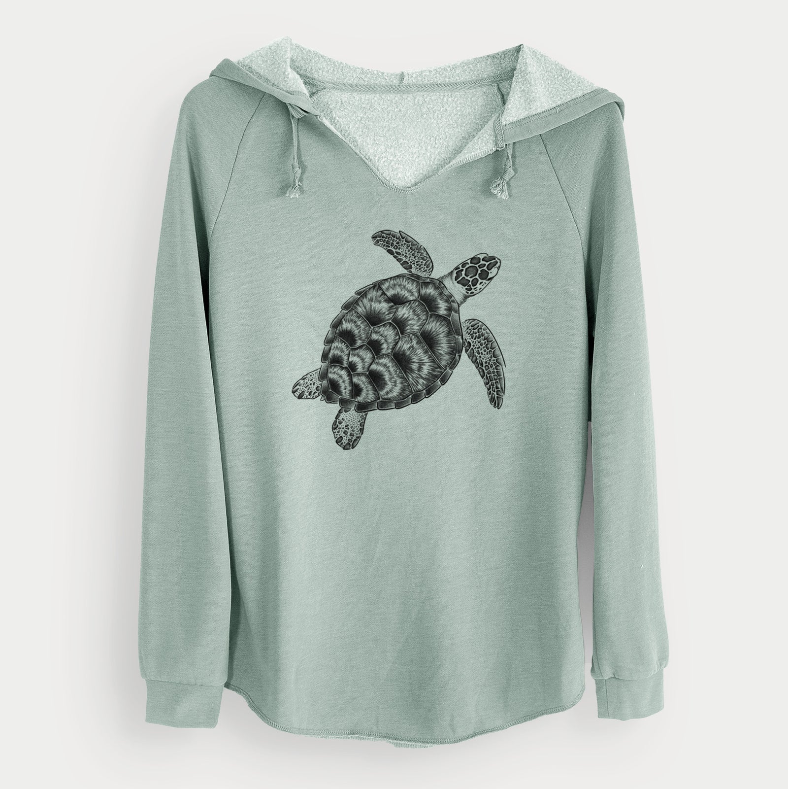 Sage green women's Cali Wave hooded sweatshirt laid flat, printed with a detailed black ink illustration of a loggerhead sea turtle swimming, seen from above.