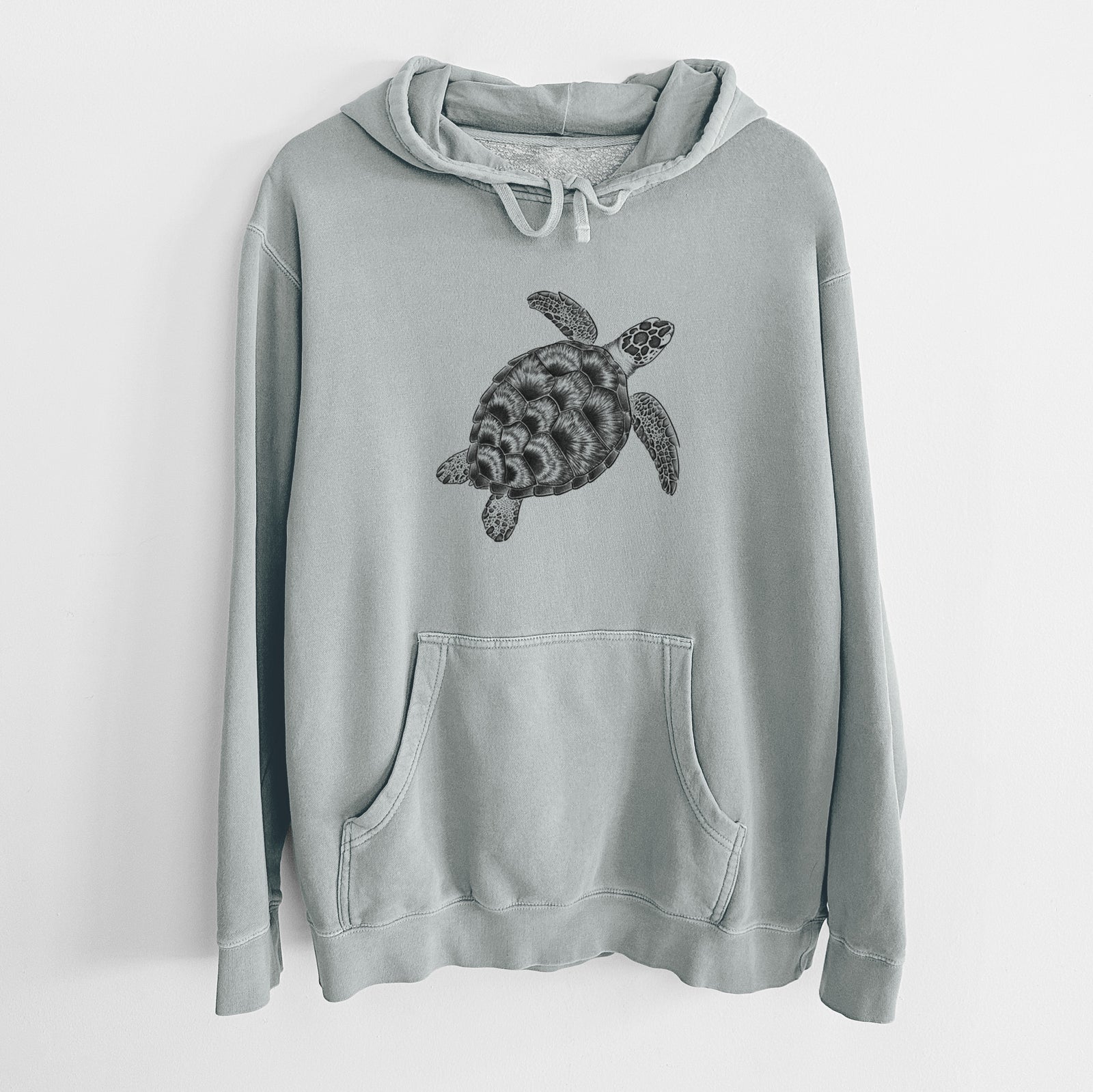Sage green pigment dyed hoodie laid flat, printed with a detailed black ink illustration of a loggerhead sea turtle swimming, seen from above.