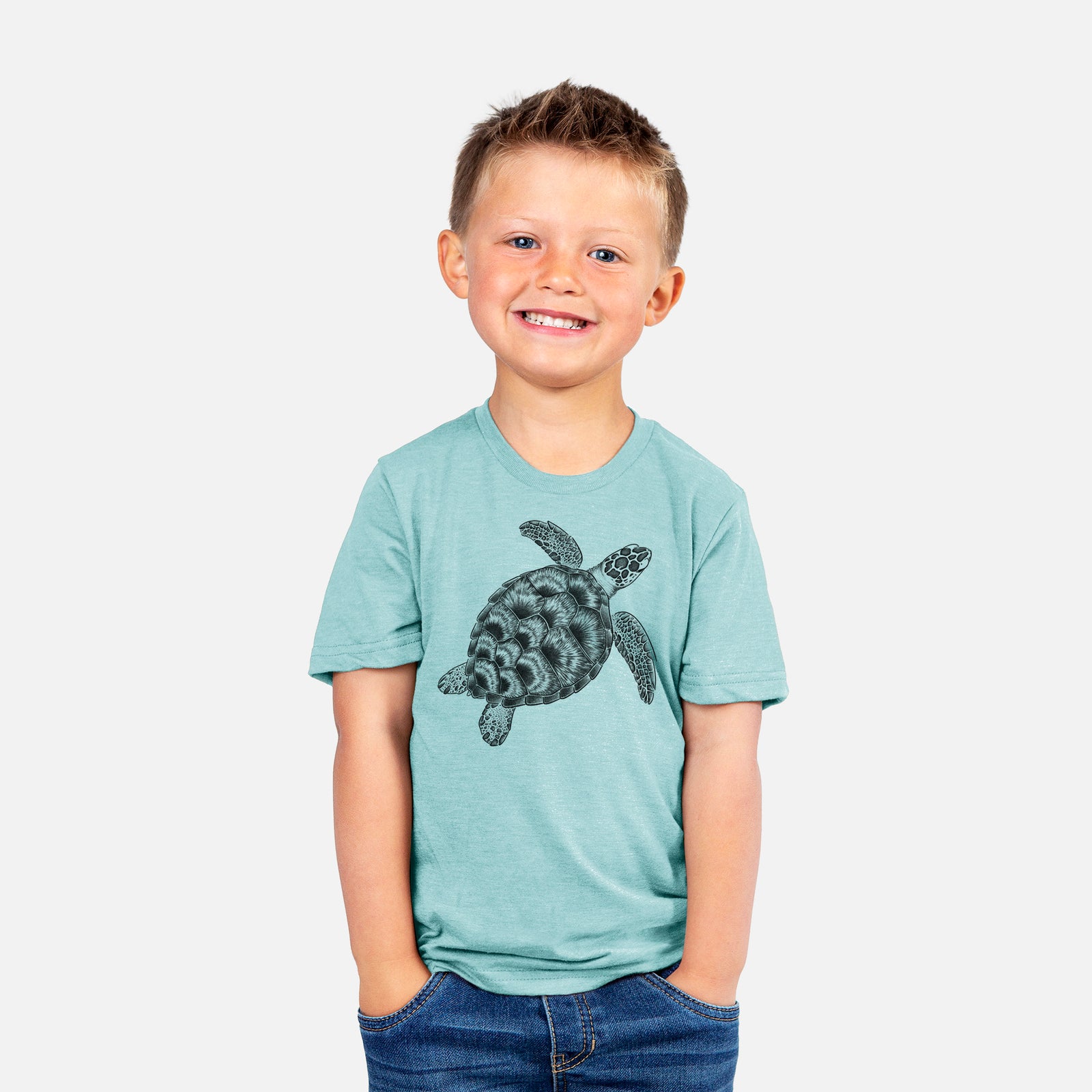 Two youth t-shirts in different colors on hangers, printed with a detailed black ink illustration of a loggerhead sea turtle swimming, seen from above.
