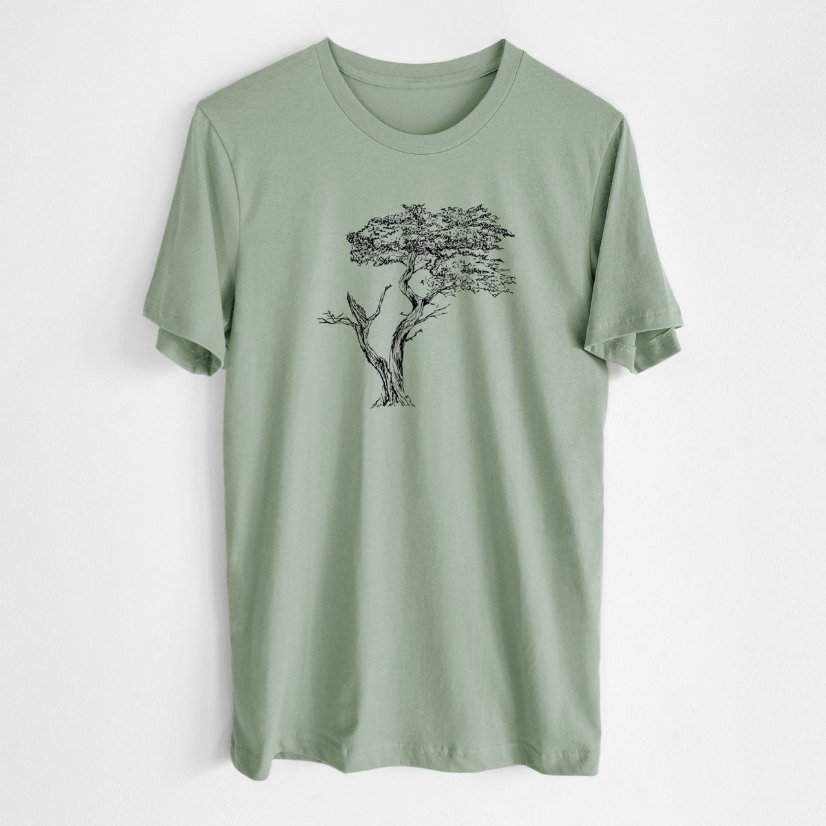 Sage green lightweight cotton t-shirt laid flat, printed with a black ink illustration of the windswept Lone Cypress tree on a rocky outcrop.