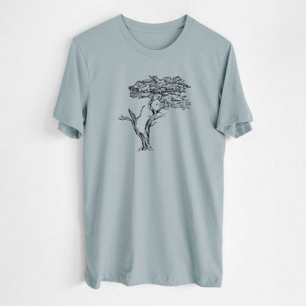 Vintage denim lightweight cotton t-shirt laid flat, printed with a black ink illustration of the windswept Lone Cypress tree on a rocky outcrop.