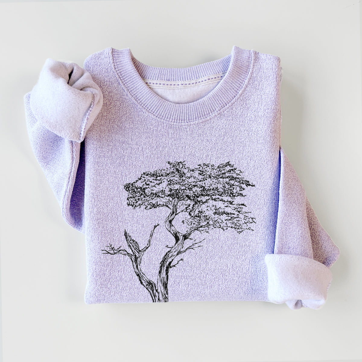 Ice purple knit sweatshirt printed with a black ink illustration of the windswept Lone Cypress tree on a rocky outcrop, styled flat.