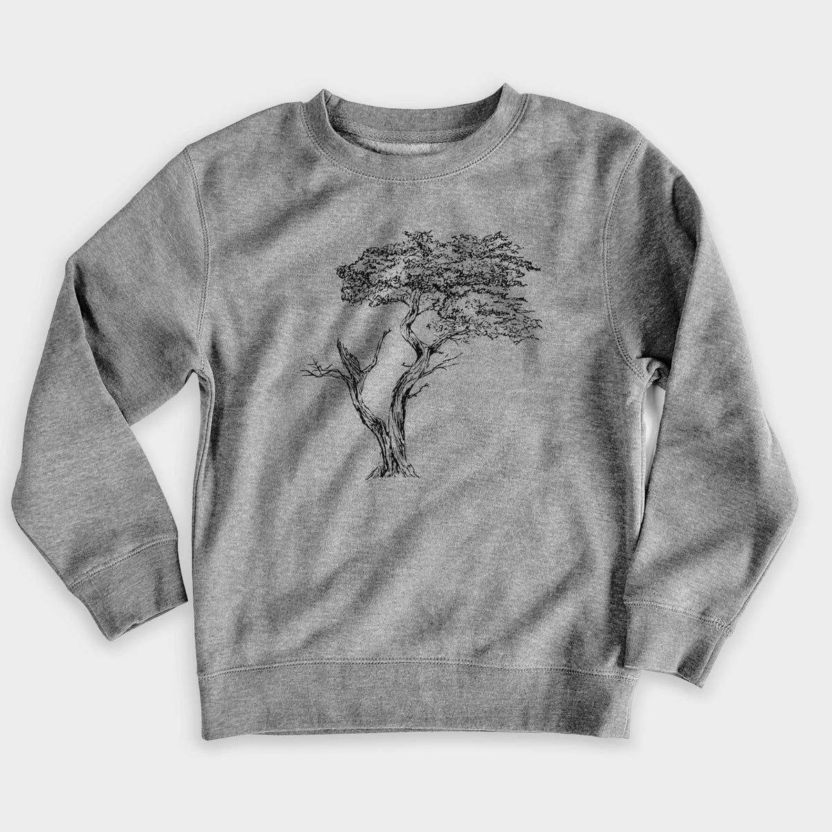 Nickel grey youth crewneck sweatshirt laid flat, printed with a black ink illustration of the windswept Lone Cypress tree on a rocky outcrop.
