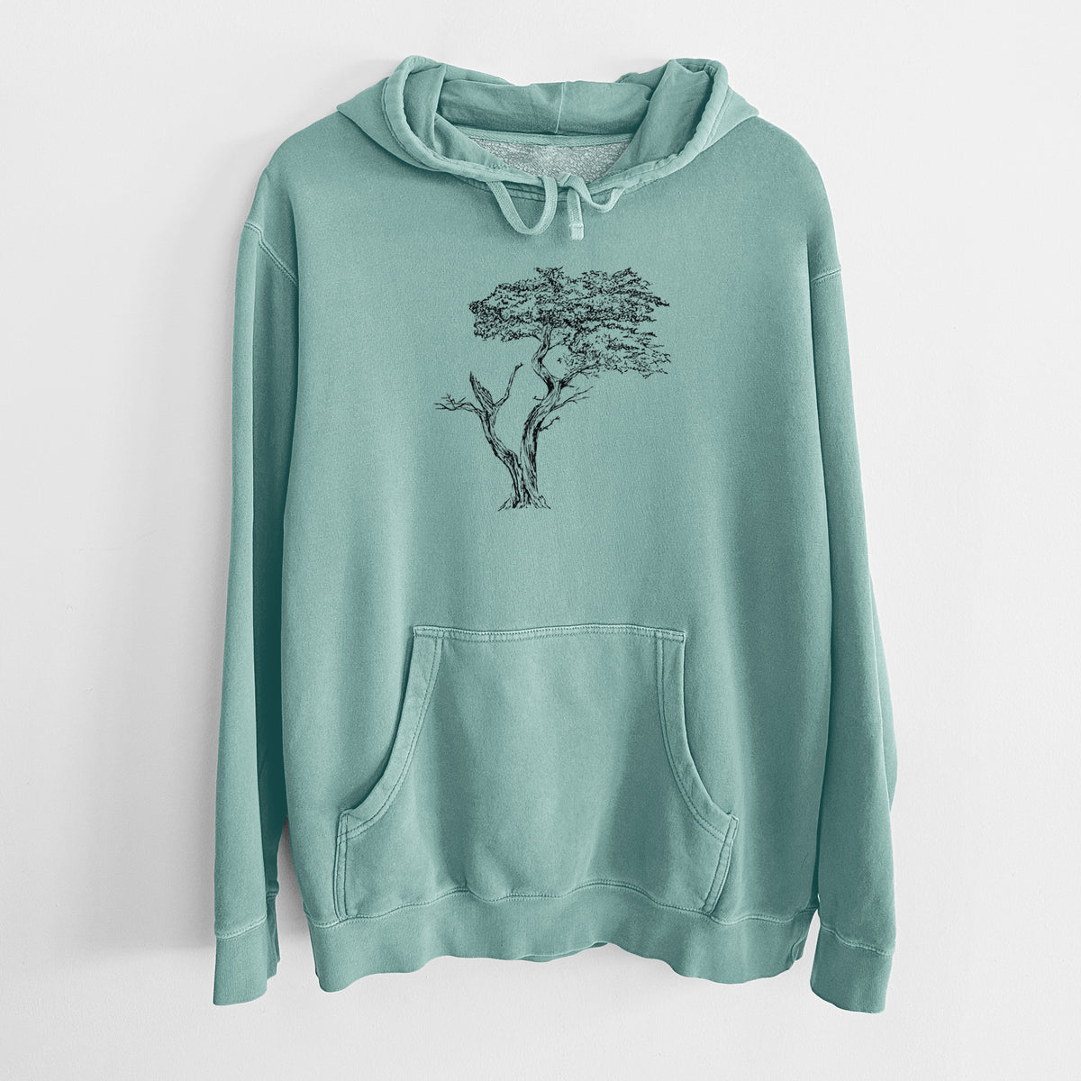 Mint green pigment dyed hoodie laid flat, printed with a black ink illustration of the windswept Lone Cypress tree on a rocky outcrop.
