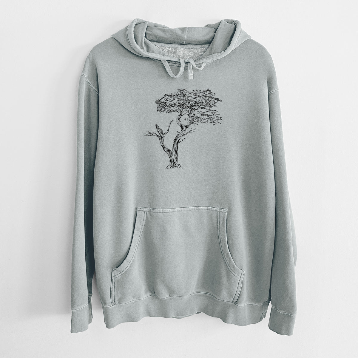 Sage green pigment dyed hoodie laid flat, printed with a black ink illustration of the windswept Lone Cypress tree on a rocky outcrop.