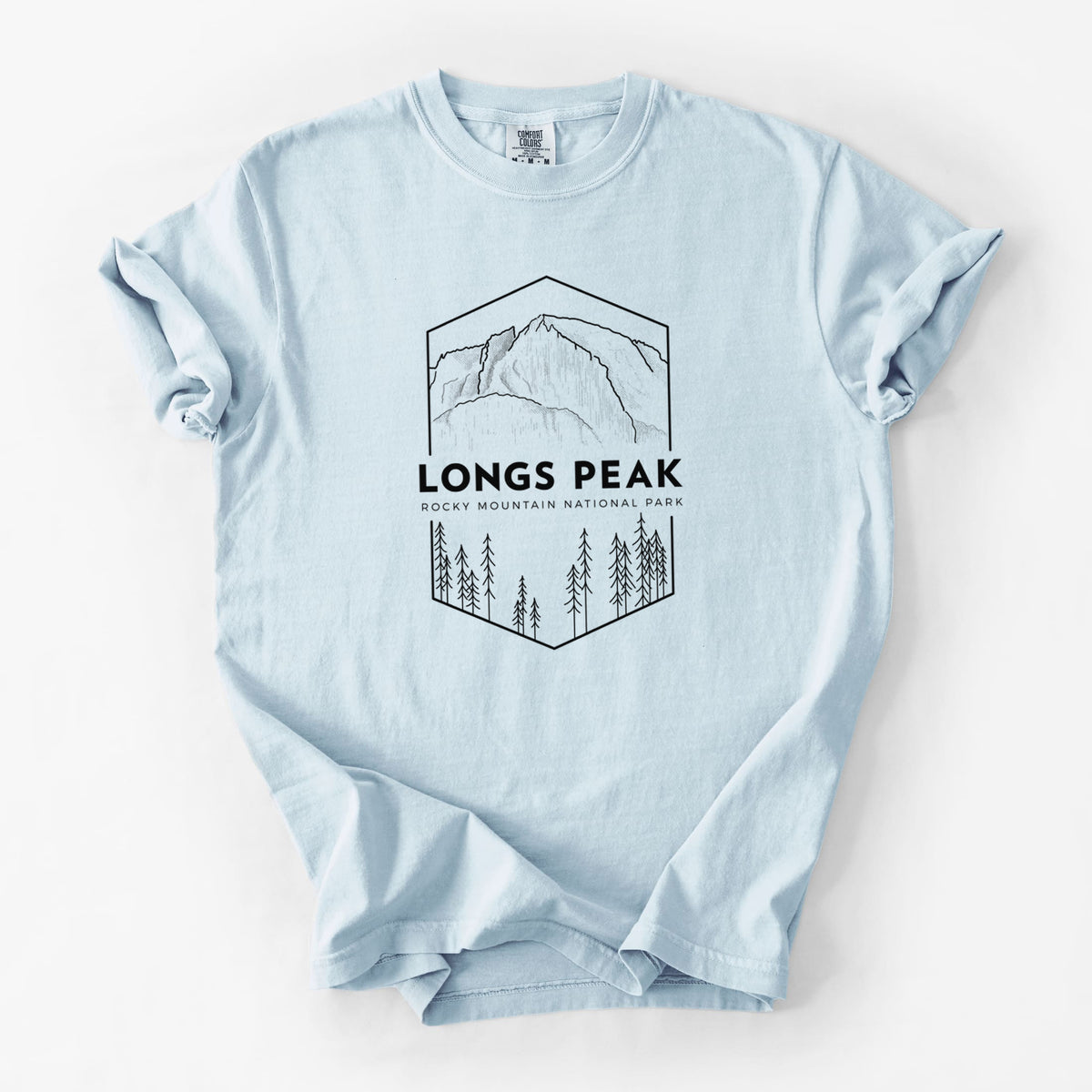 Chambray blue Comfort Colors t-shirt laid flat, printed with a black line art badge of Longs Peak above a pine forest, with the words Longs Peak, Rocky Mountain National Park.