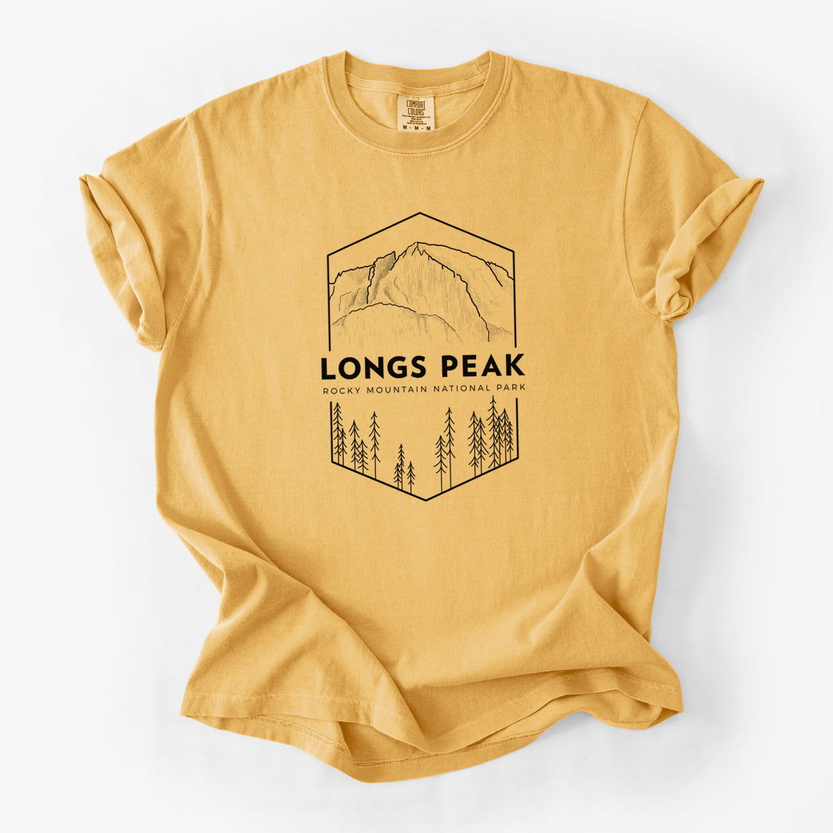 Golden wheat yellow Comfort Colors t-shirt laid flat, printed with a black line art badge of Longs Peak above a pine forest, with the words Longs Peak, Rocky Mountain National Park.