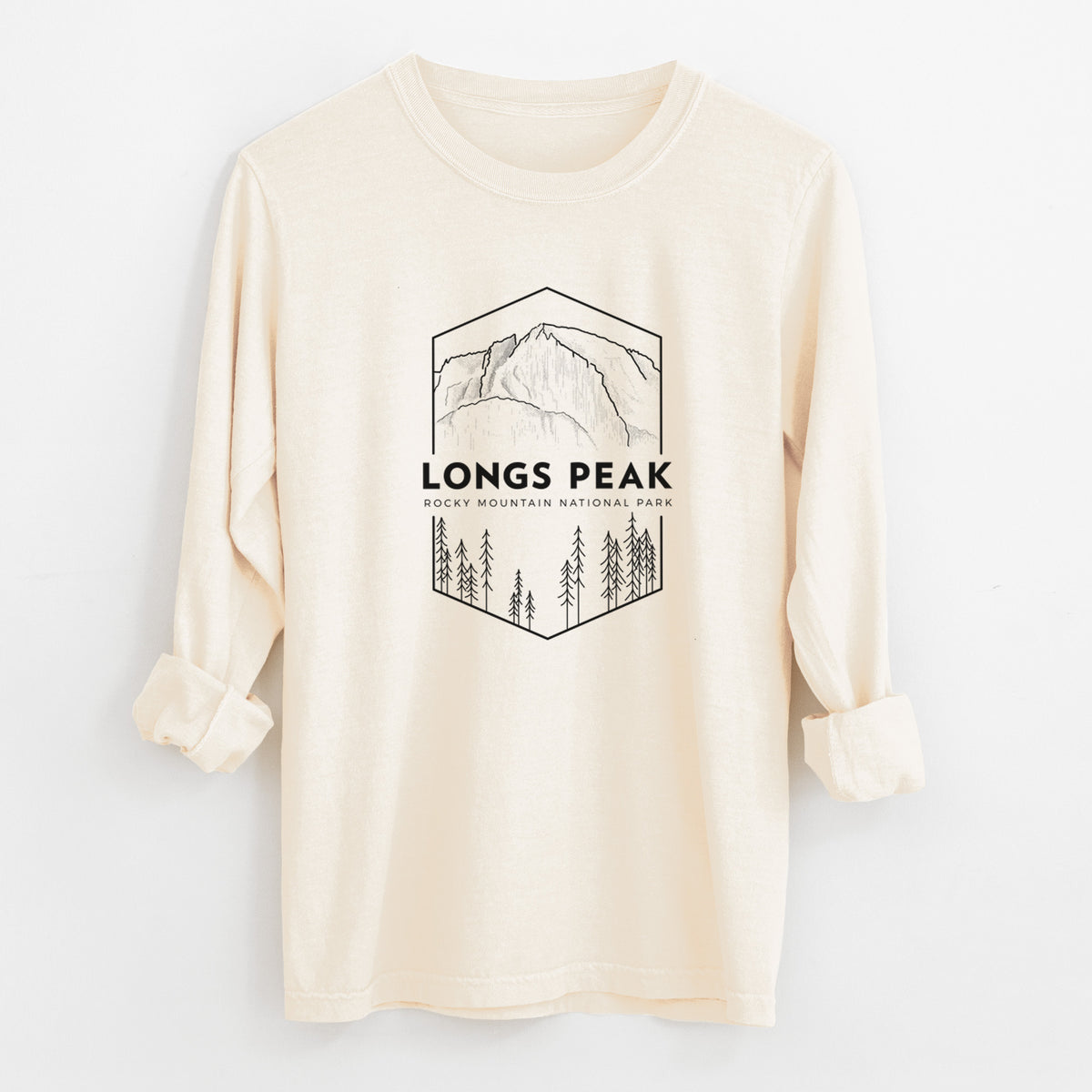 Ivory Comfort Colors long sleeve shirt laid flat with the cuffs rolled, printed with a black line art badge of Longs Peak above a pine forest, with the words Longs Peak, Rocky Mountain National Park.