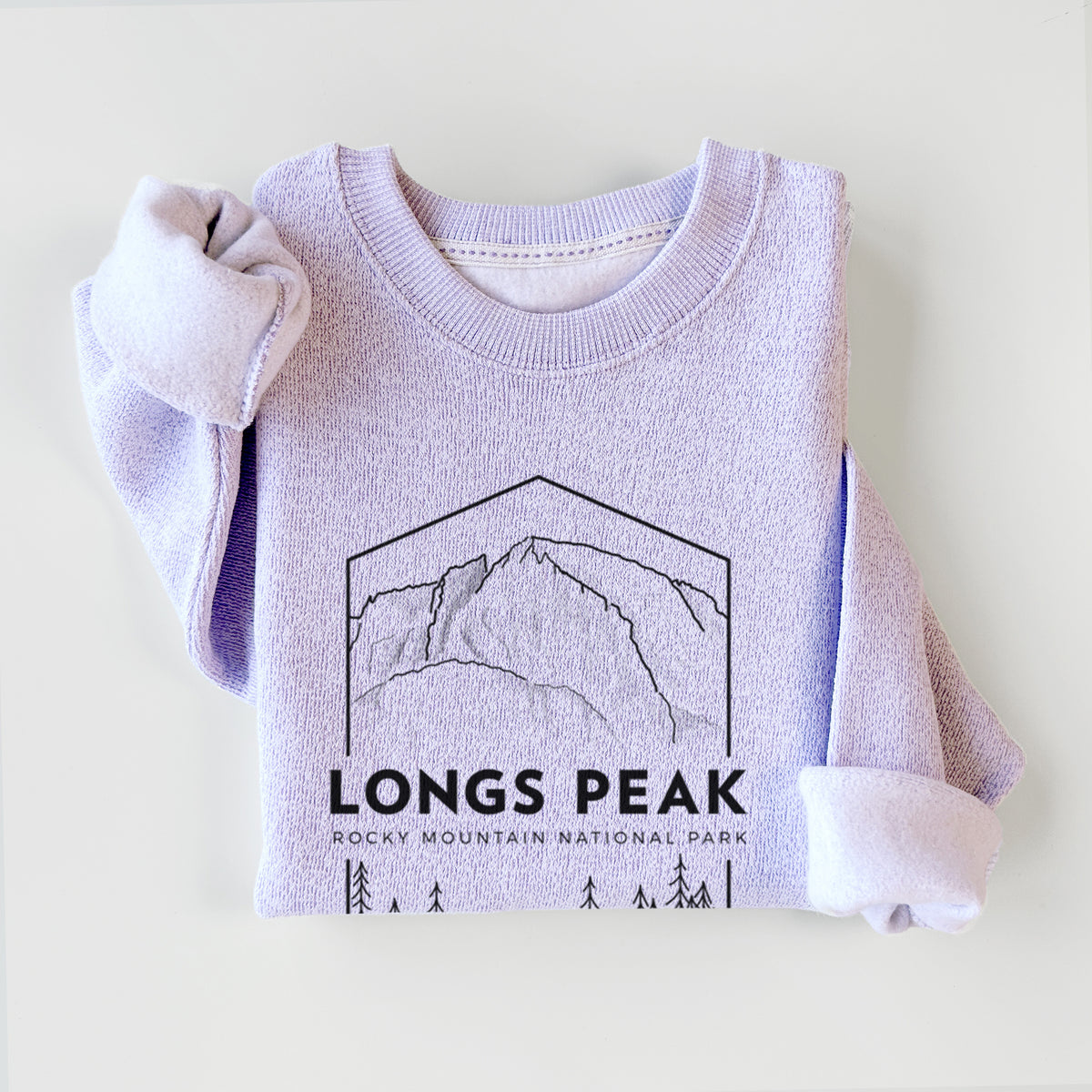 Ice purple knit sweatshirt printed with a black line art badge of Longs Peak above a pine forest, with the words Longs Peak, Rocky Mountain National Park, styled flat.