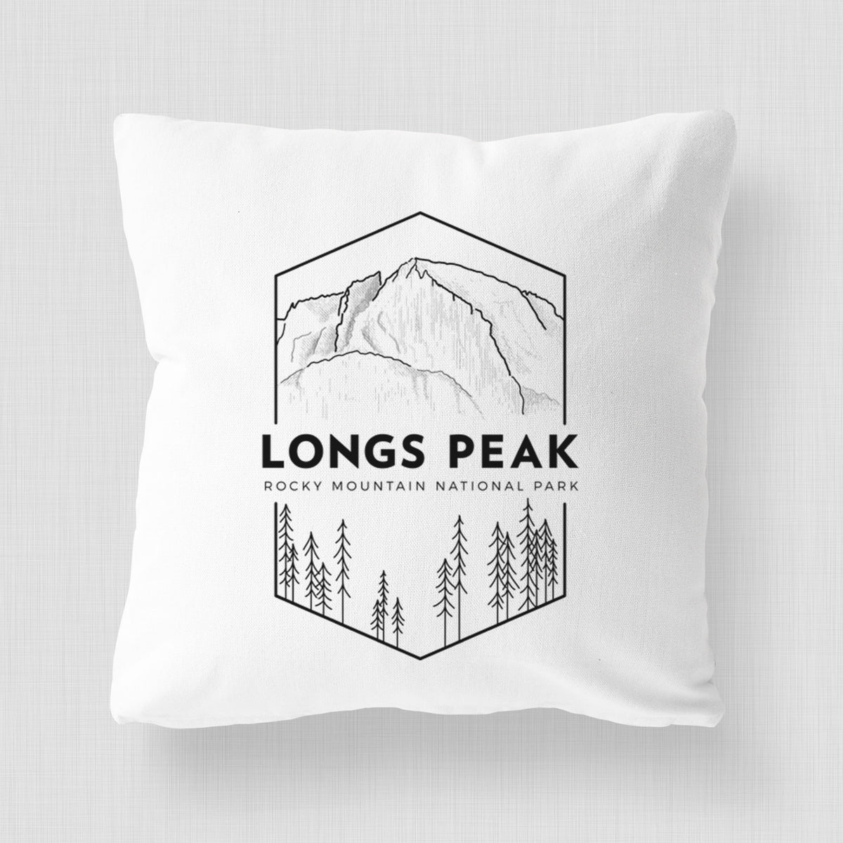 White pillow cover printed with a black line art badge of Longs Peak above a pine forest, with the words Longs Peak, Rocky Mountain National Park.