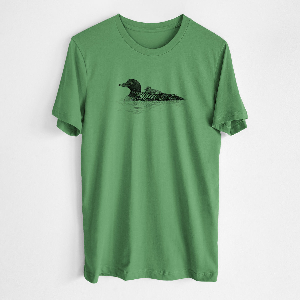 Leaf green lightweight cotton t-shirt laid flat, printed with a black ink sketch of a common loon floating on water with a chick riding on its back.