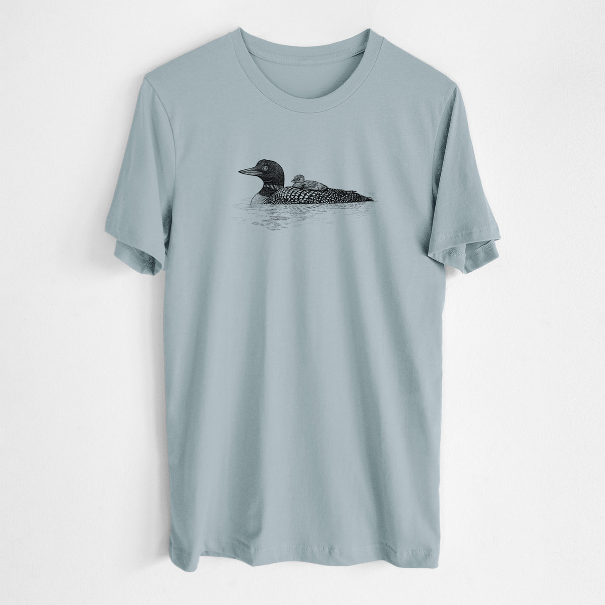 Vintage denim lightweight cotton t-shirt laid flat, printed with a black ink sketch of a common loon floating on water with a chick riding on its back.