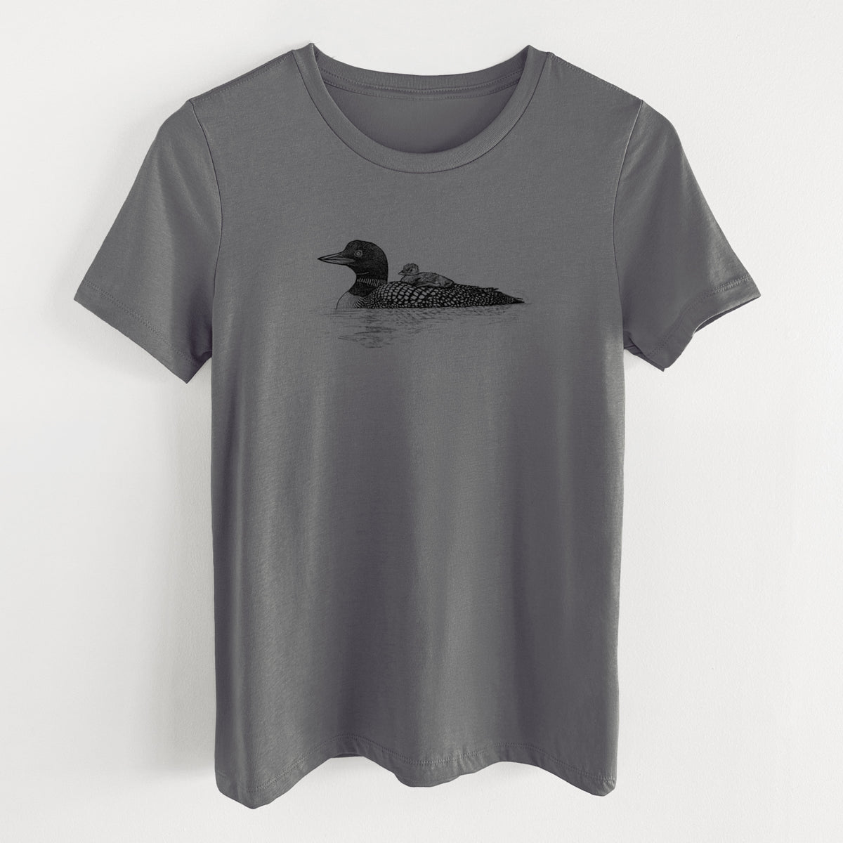 Asphalt women's relaxed fit cotton t-shirt laid flat, printed with a black ink sketch of a common loon floating on water with a chick riding on its back.