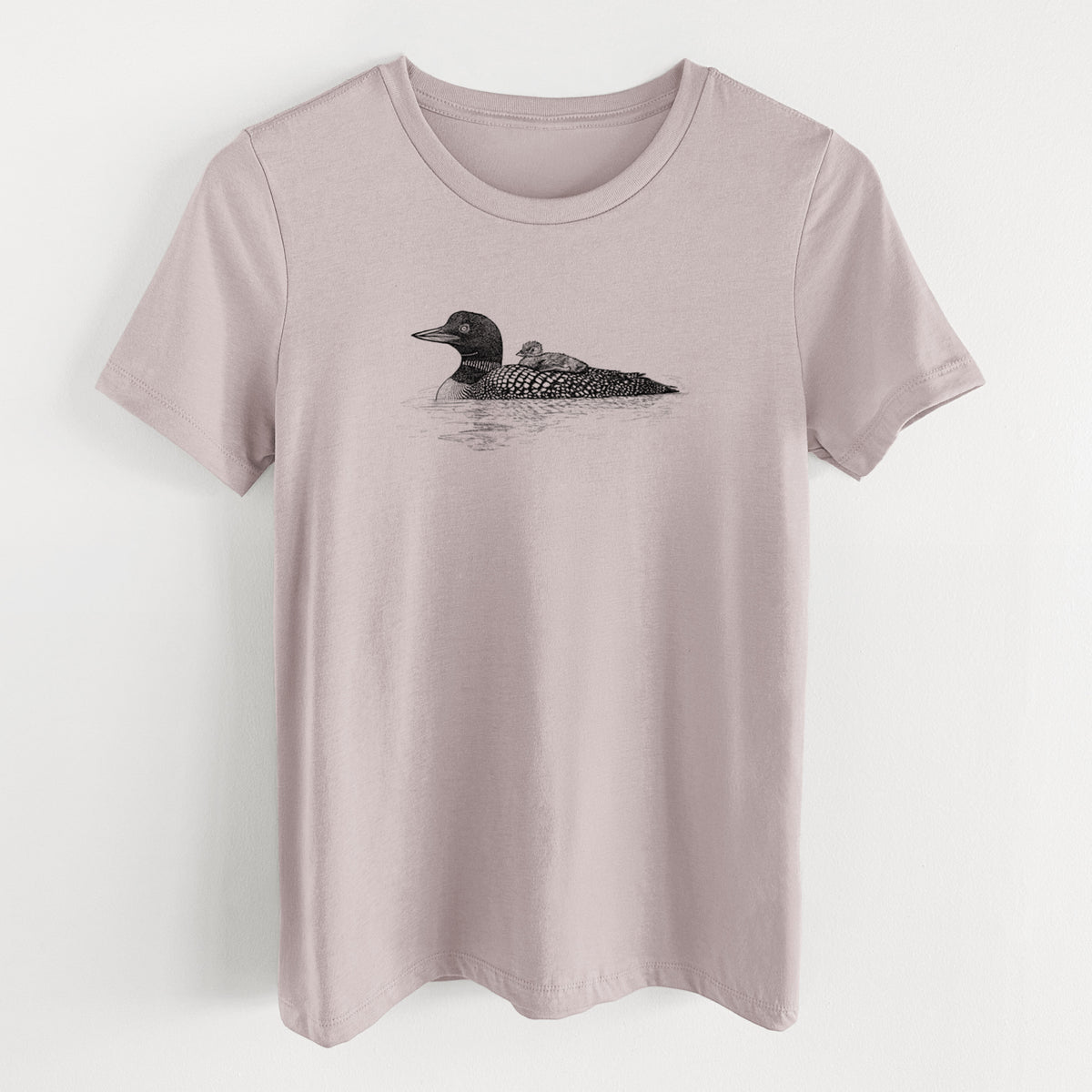 Pink gravel women's relaxed fit cotton t-shirt laid flat, printed with a black ink sketch of a common loon floating on water with a chick riding on its back.