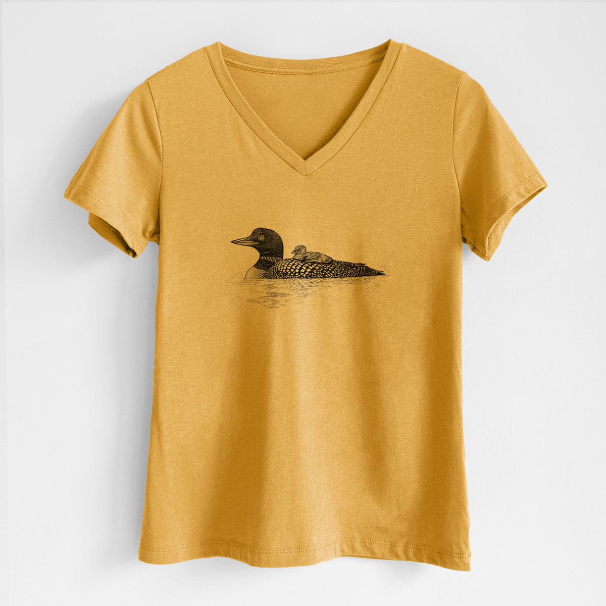 Honeycomb yellow women's relaxed fit cotton V-neck t-shirt laid flat, printed with a black ink sketch of a common loon floating on water with a chick riding on its back.