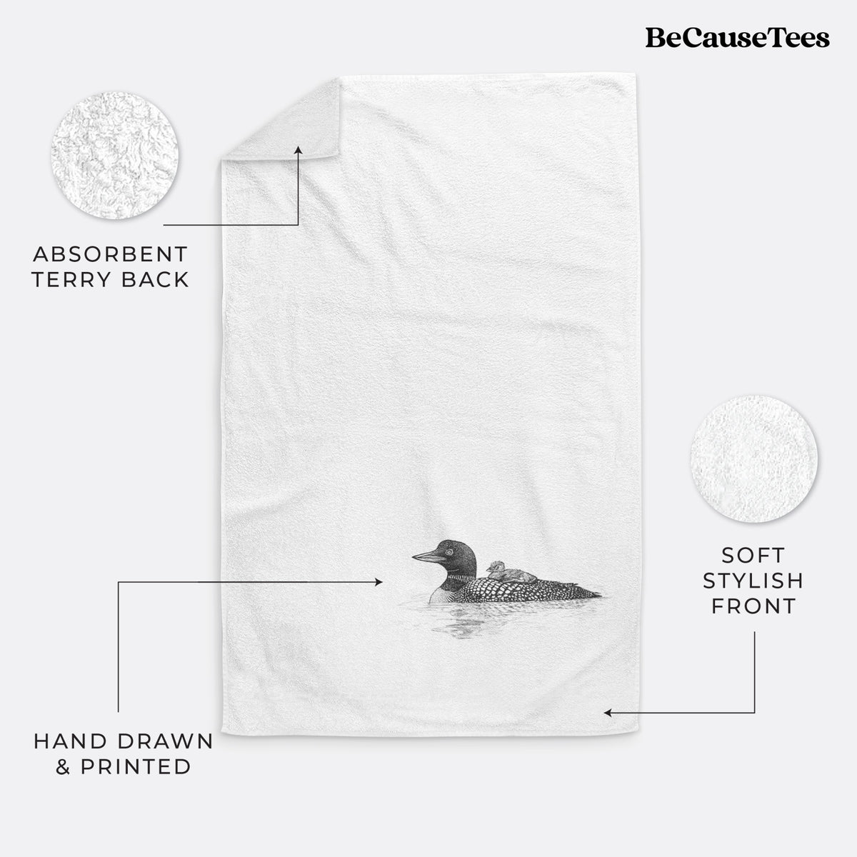 White hand towel printed with a black ink sketch of a common loon floating on water with a chick riding on its back.