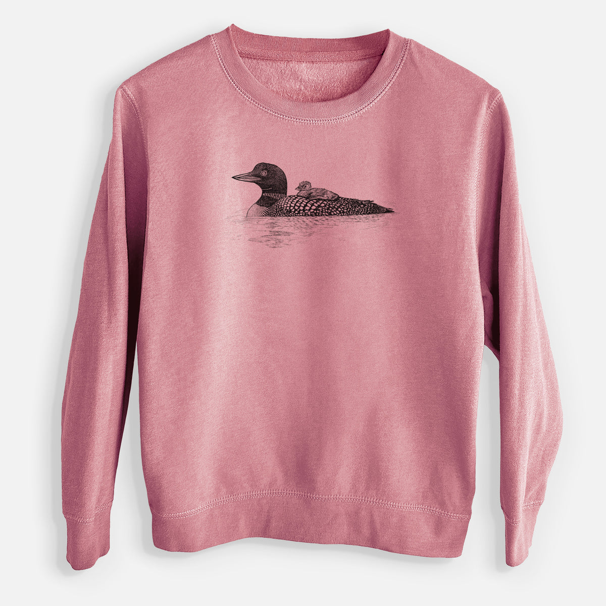 Mauve pink youth crewneck sweatshirt laid flat, printed with a black ink sketch of a common loon floating on water with a chick riding on its back.