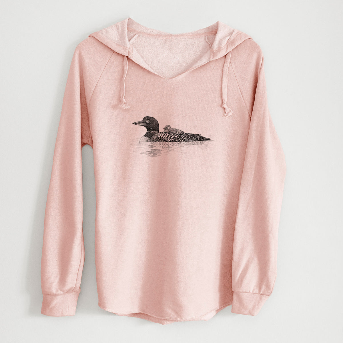 Blush pink women's Cali Wave hooded sweatshirt laid flat, printed with a black ink sketch of a common loon floating on water with a chick riding on its back.