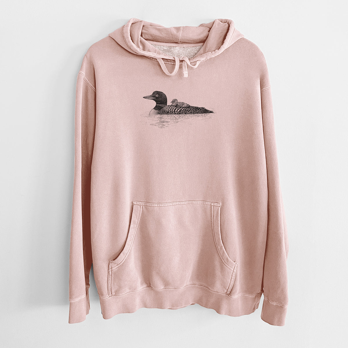 Dusty pink pigment dyed hoodie laid flat, printed with a black ink sketch of a common loon floating on water with a chick riding on its back.