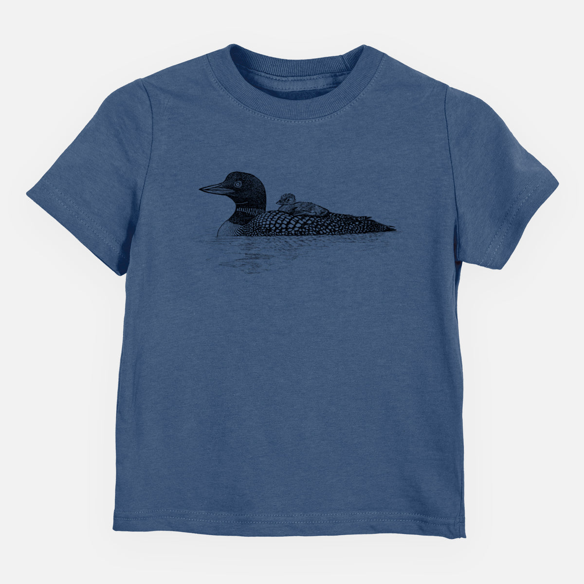 Indigo blue toddler t-shirt laid flat, printed with a black ink sketch of a common loon floating on water with a chick riding on its back.
