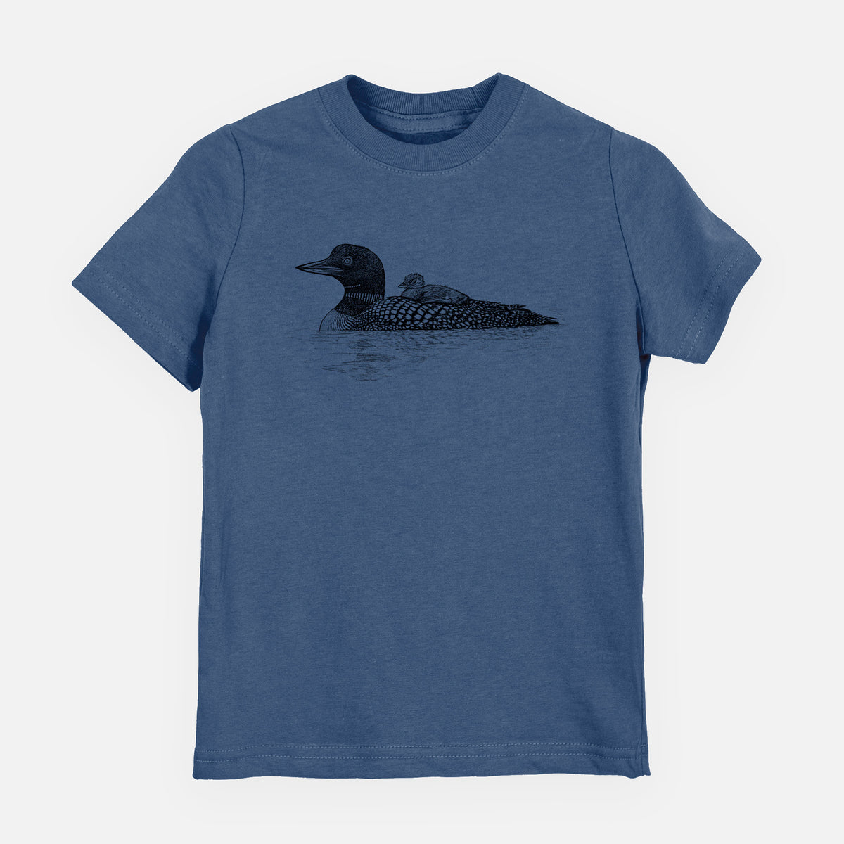Indigo blue youth t-shirt laid flat, printed with a black ink sketch of a common loon floating on water with a chick riding on its back.