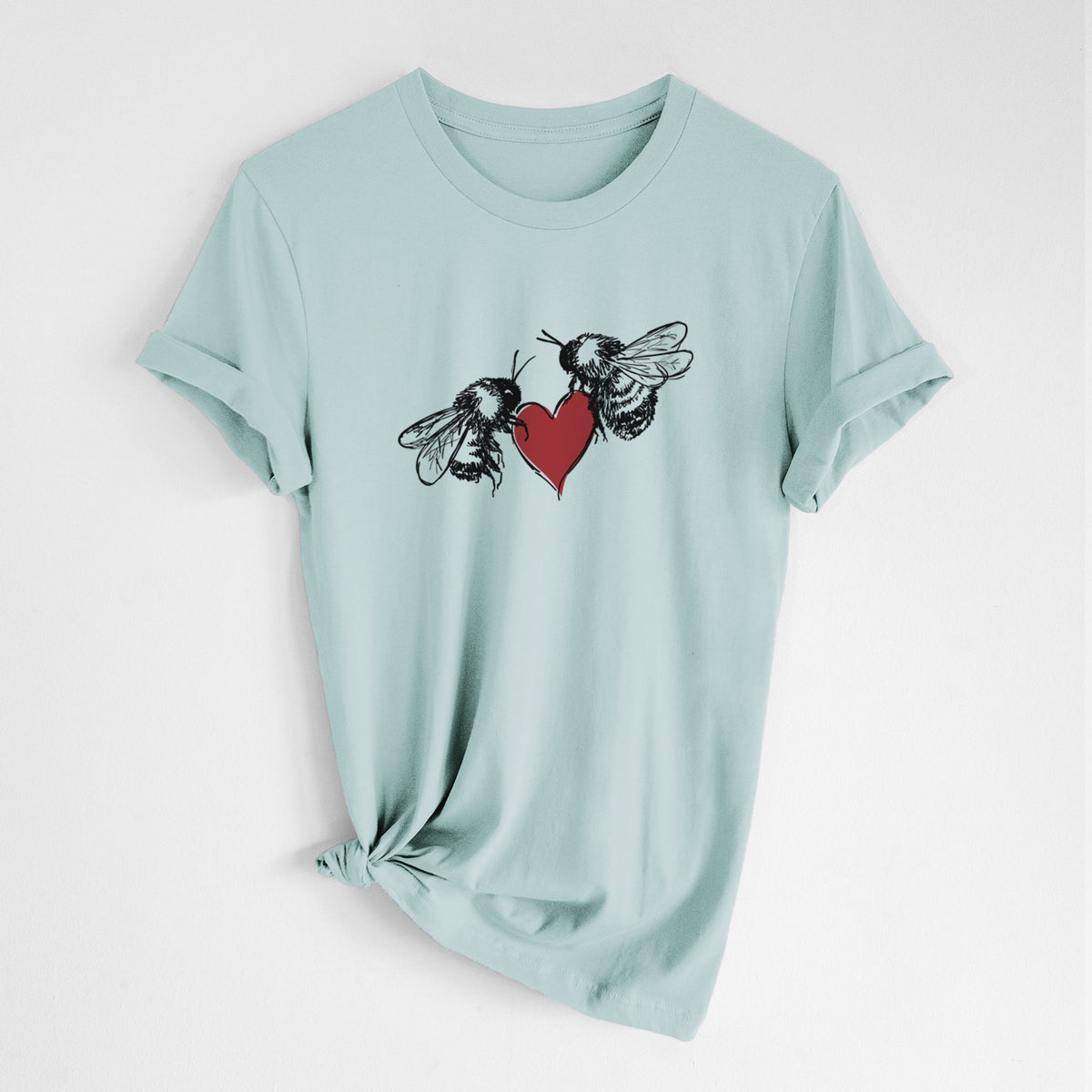 Dusty blue lightweight cotton t-shirt laid flat with the sleeves rolled, printed with a black ink illustration of two bees facing each other with a red heart between them.