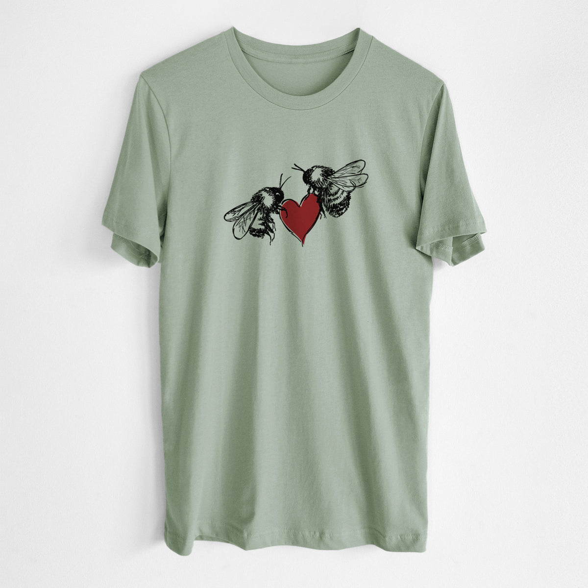 Sage green lightweight cotton t-shirt laid flat, printed with a black ink illustration of two bees facing each other with a red heart between them.