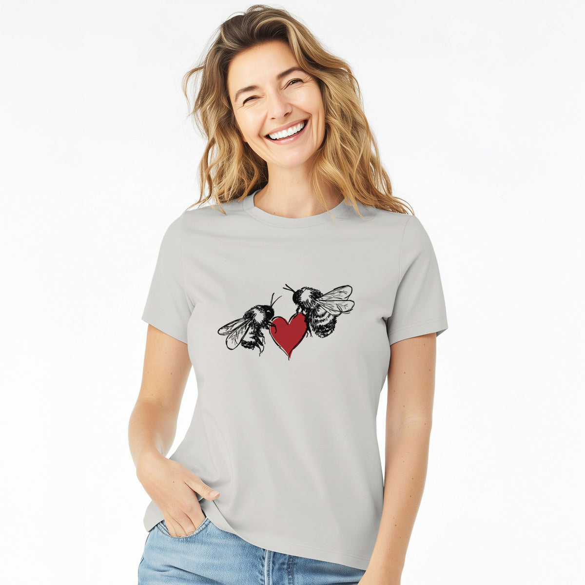 Woman wearing a lunar grey women's relaxed fit cotton t-shirt printed with a black ink illustration of two bees facing each other with a red heart between them.
