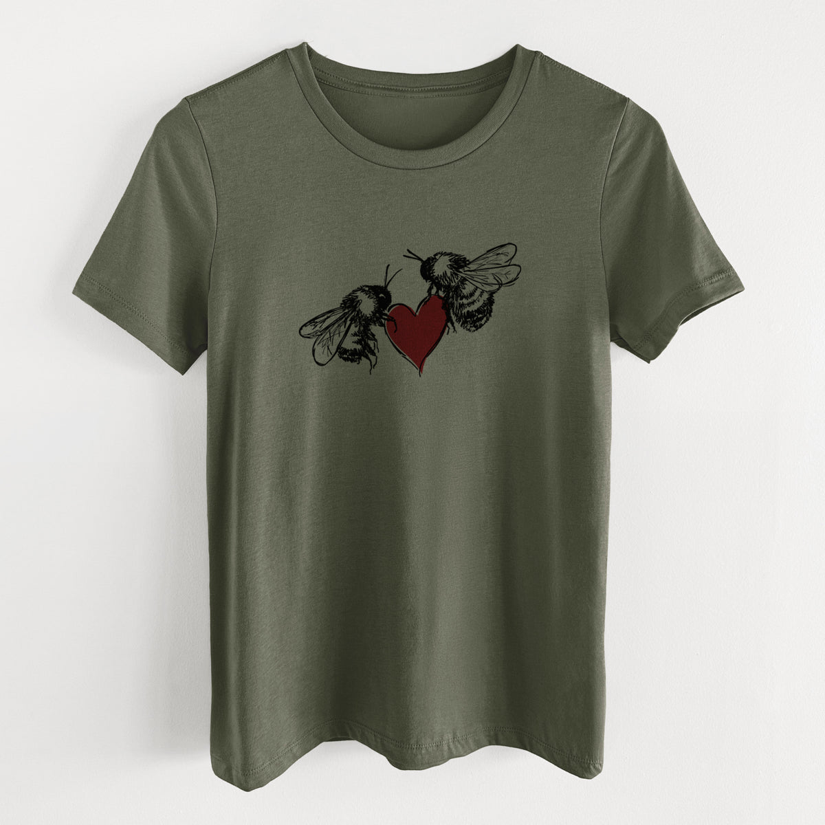Military green women's relaxed fit cotton t-shirt laid flat, printed with a black ink illustration of two bees facing each other with a red heart between them.