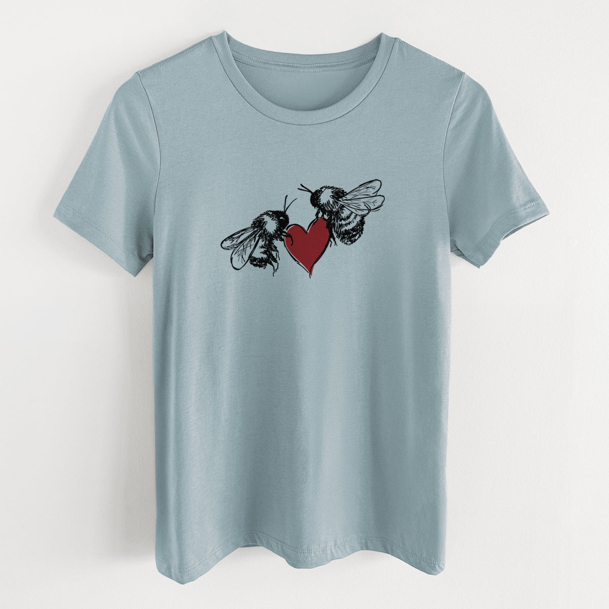 Vintage denim women's relaxed fit cotton t-shirt laid flat, printed with a black ink illustration of two bees facing each other with a red heart between them.