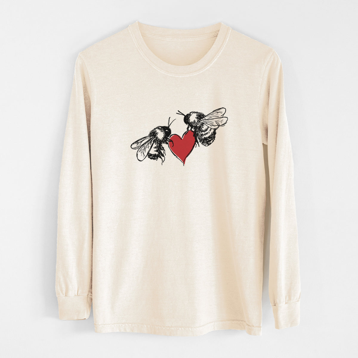 Ivory Comfort Colors long sleeve shirt laid flat, printed with a black ink illustration of two bees facing each other with a red heart between them.