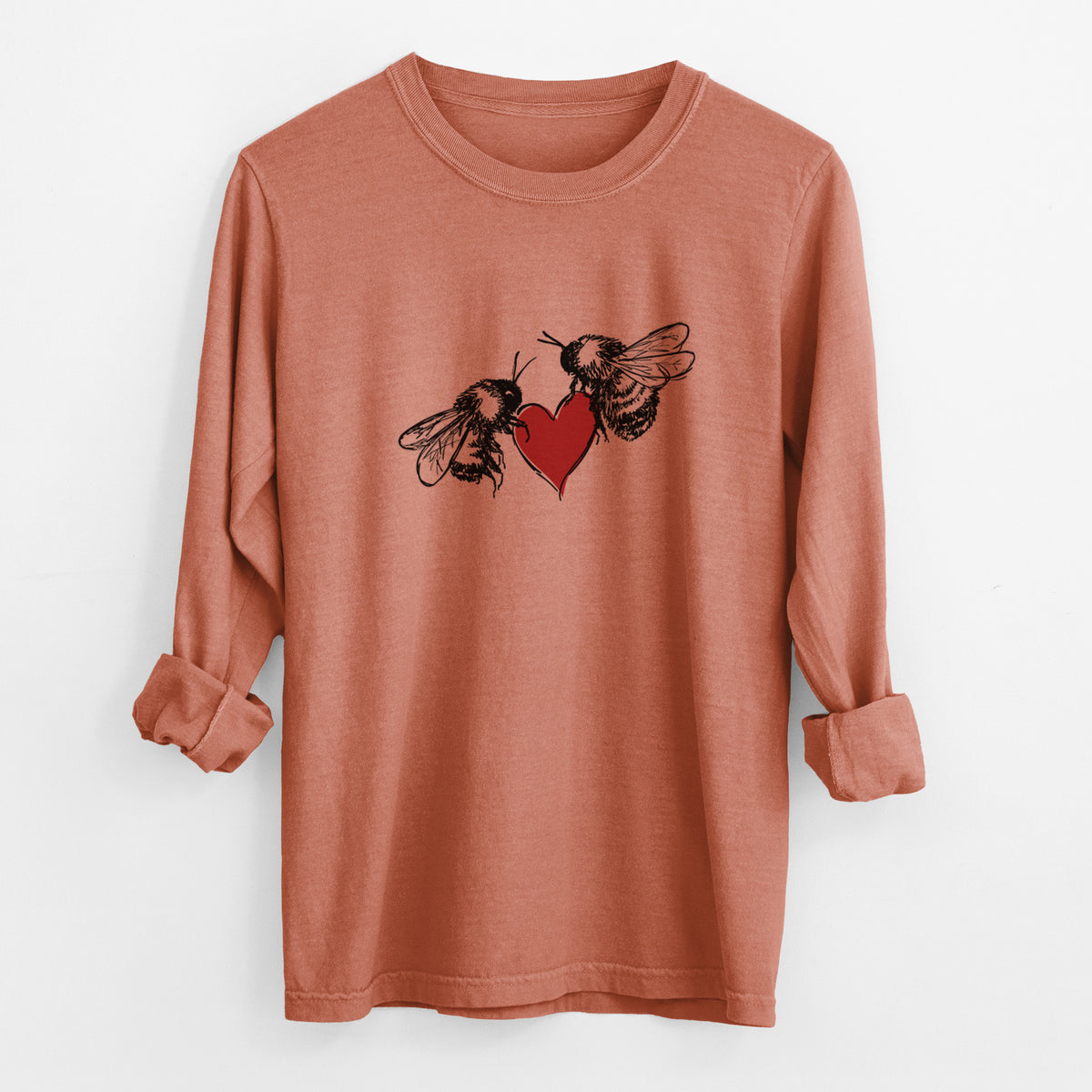 Yam burnt orange Comfort Colors long sleeve shirt laid flat with the cuffs rolled, printed with a black ink illustration of two bees facing each other with a red heart between them.