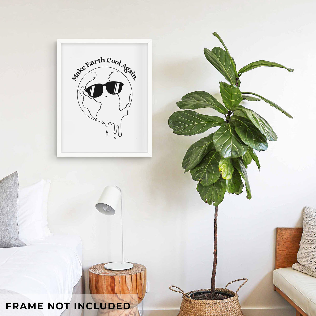 Art print of a melting Earth wearing black sunglasses, with the words Make Earth Cool Again, shown framed on a living room wall beside a potted plant. Frame not included.