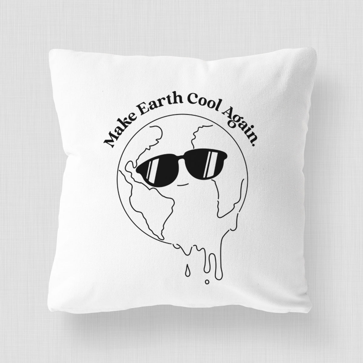 White pillow cover printed with a melting Earth wearing black sunglasses, with the words Make Earth Cool Again.