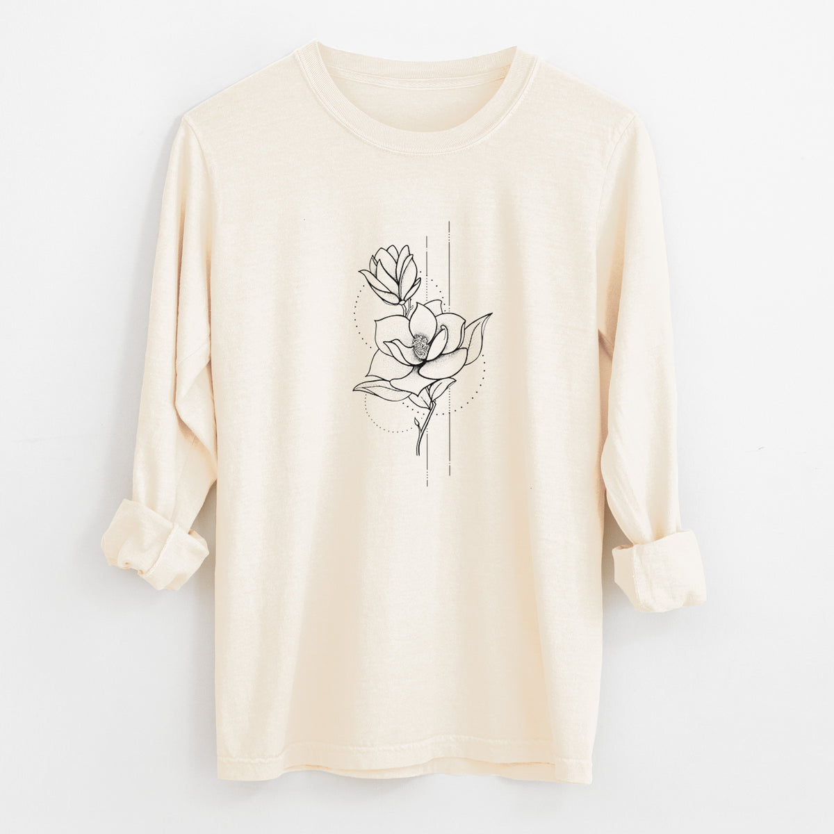 Ivory Comfort Colors long sleeve shirt laid flat with the cuffs rolled, printed with a black ink line drawing of a magnolia blossom on a stem.