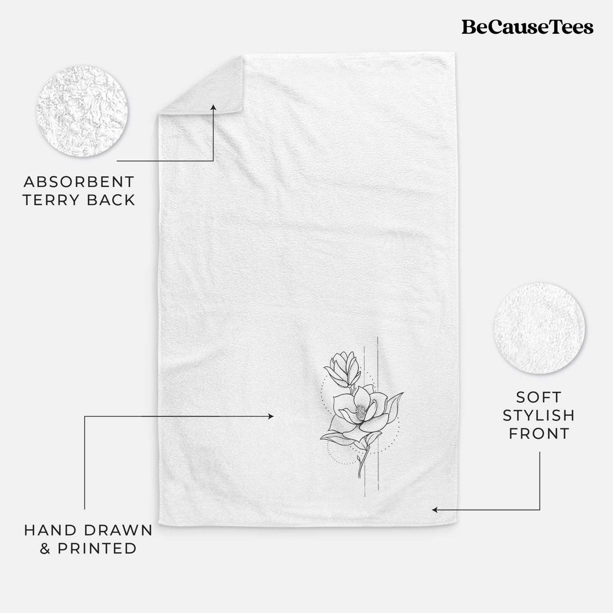 White hand towel printed with a black ink line drawing of a magnolia blossom on a stem.