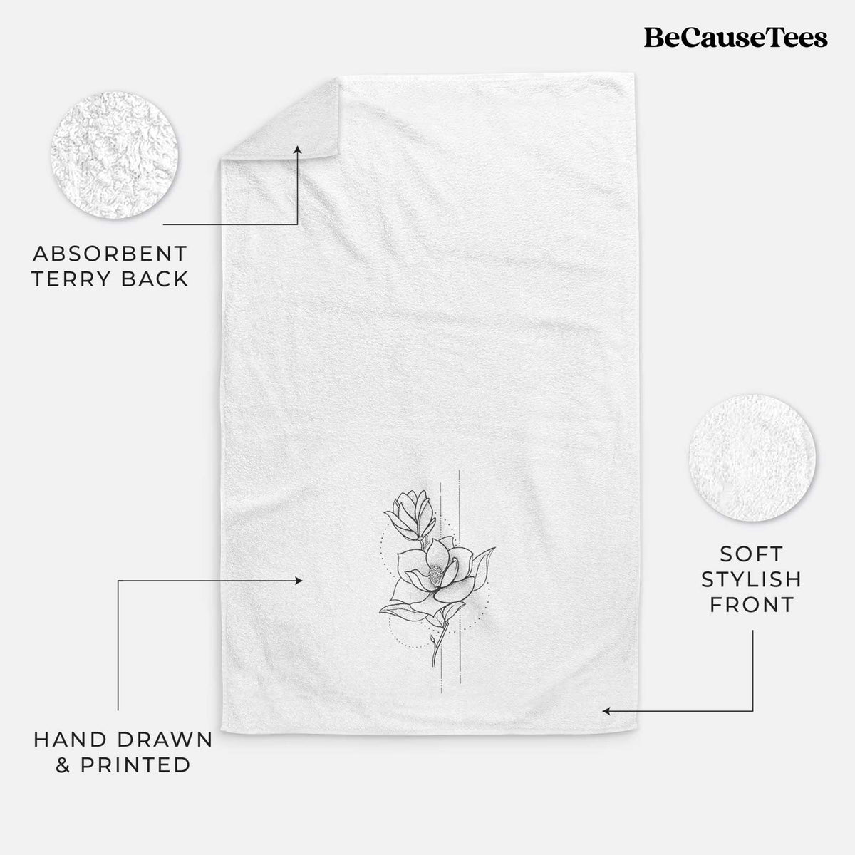 White hand towel printed with a black ink line drawing of a magnolia blossom on a stem.