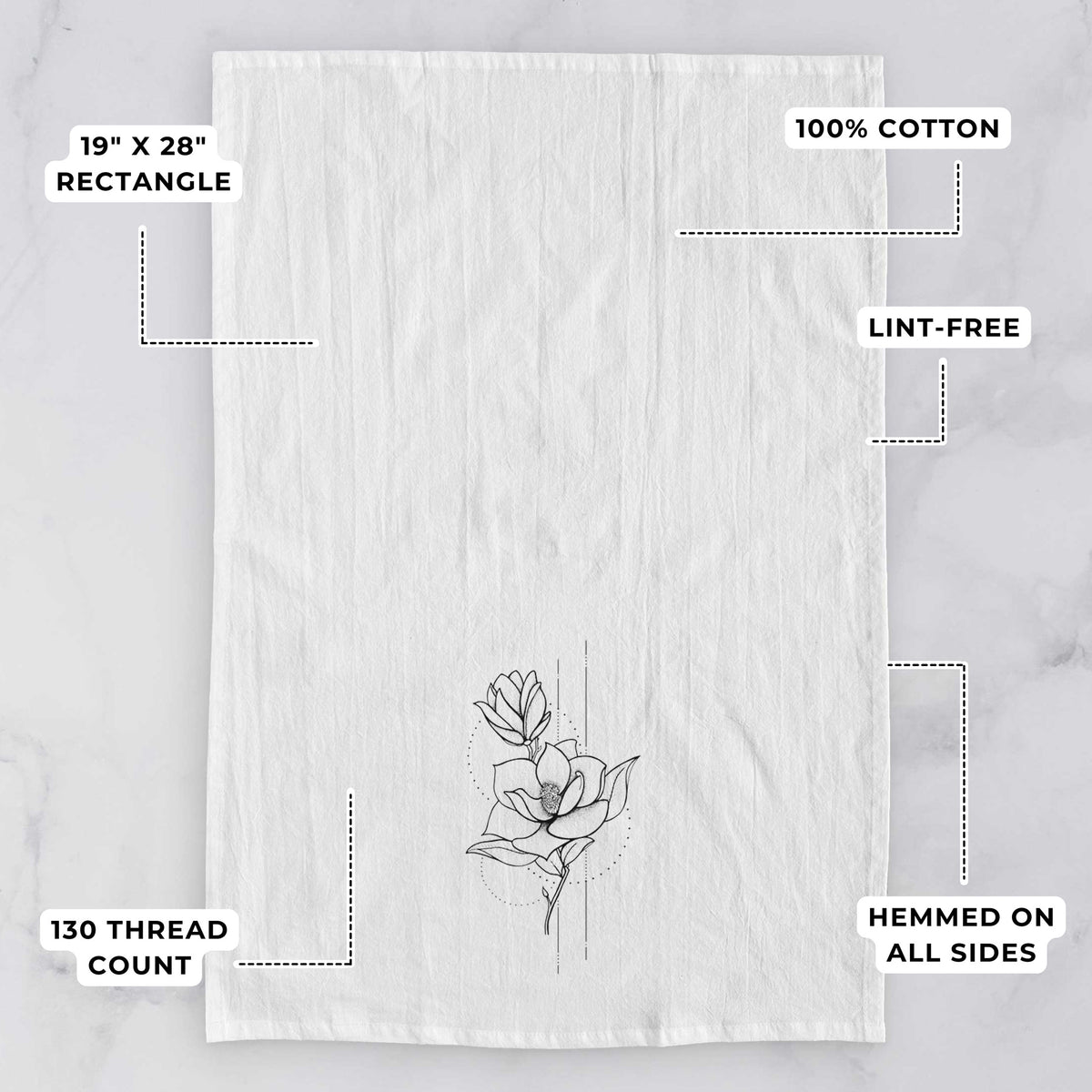 White tea towel printed with a black ink line drawing of a magnolia blossom on a stem, with feature labels: 19 by 28 inch rectangle, 100% cotton, lint-free, 130 thread count, hemmed on all sides.