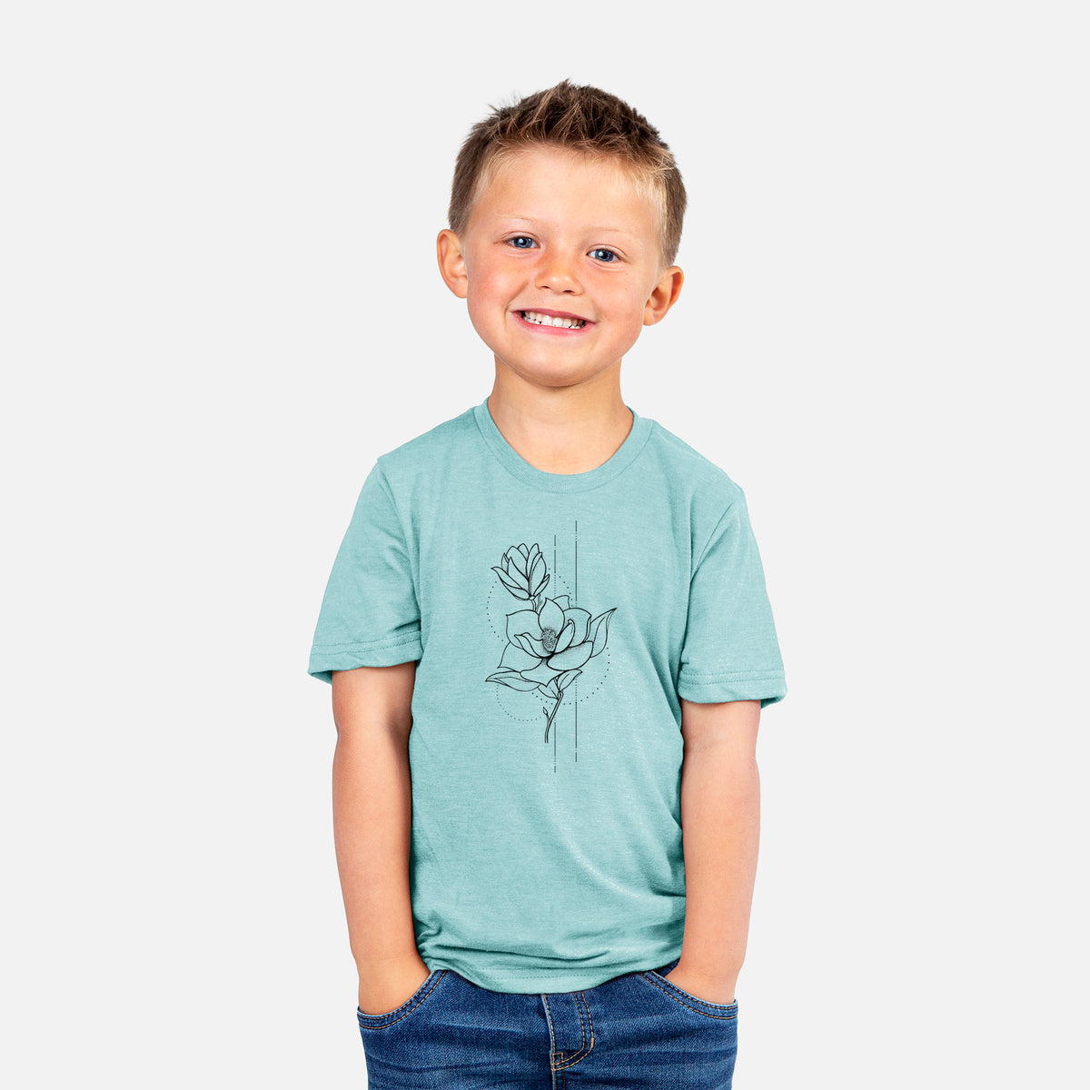 Smiling boy wearing a youth t-shirt printed with a black ink line drawing of a magnolia blossom on a stem.