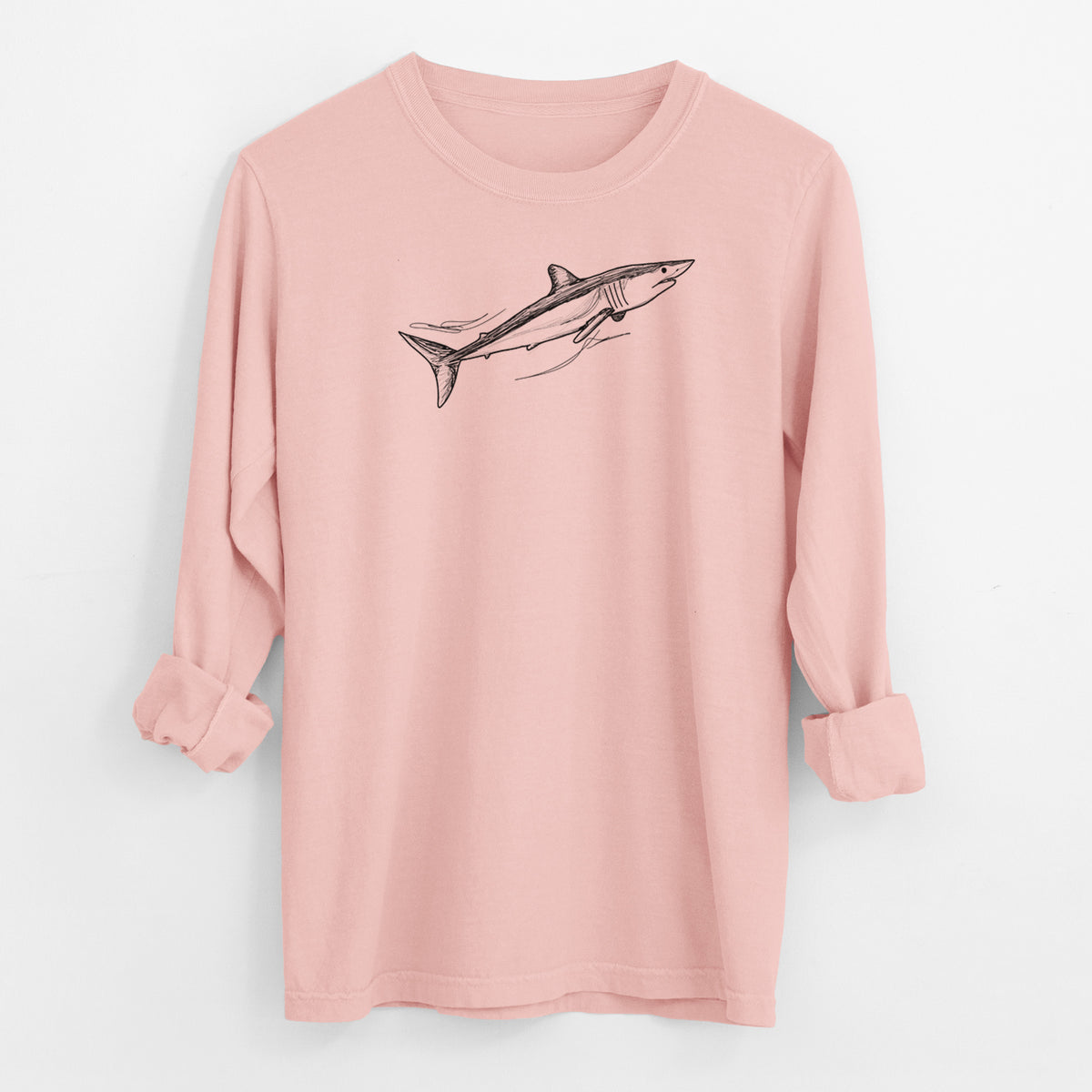 Peachy Comfort Colors long sleeve shirt laid flat with the cuffs rolled, printed with a black ink illustration of a mako shark swimming.