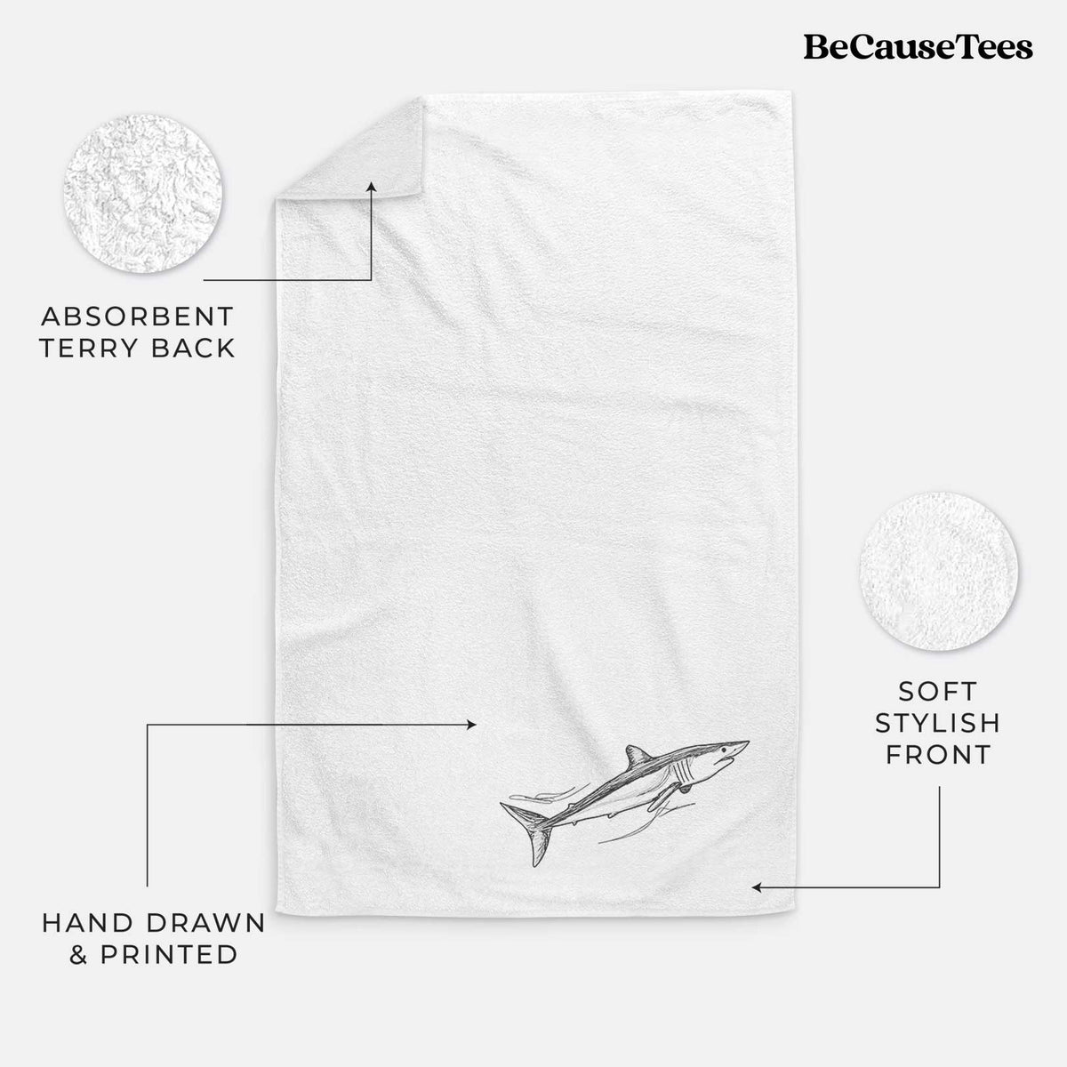 White hand towel printed with a black ink illustration of a mako shark swimming.