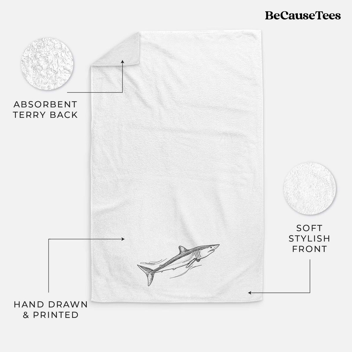 White hand towel printed with a black ink illustration of a mako shark swimming.