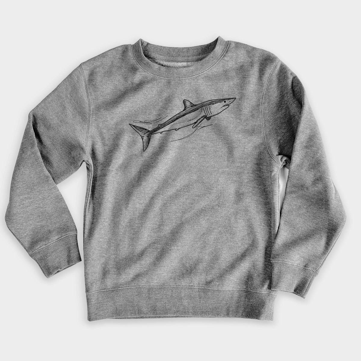 Nickel grey youth crewneck sweatshirt laid flat, printed with a black ink illustration of a mako shark swimming.