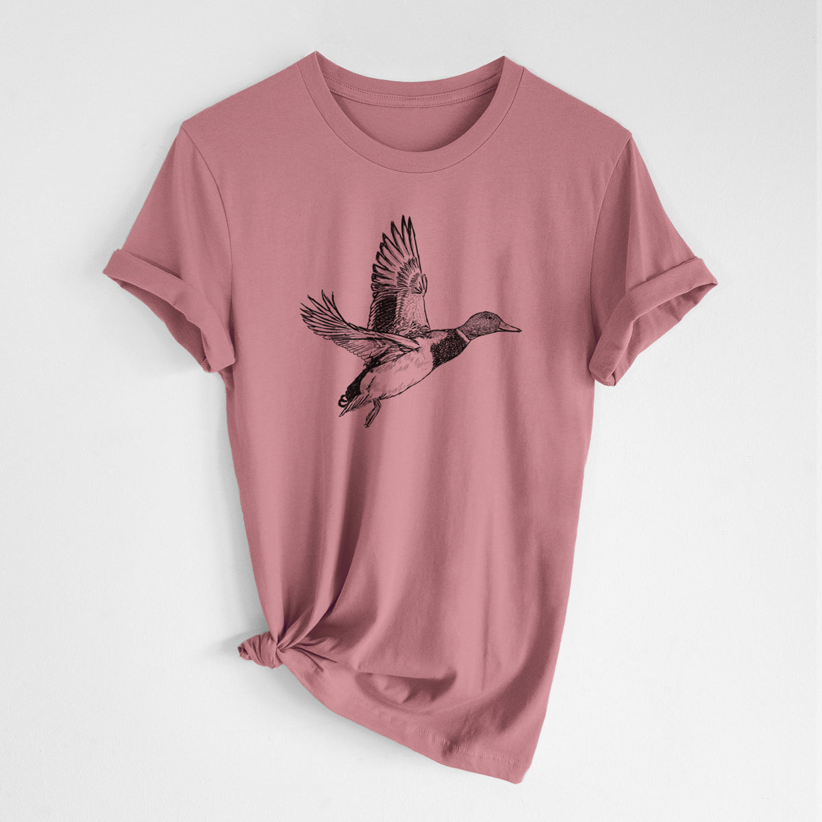 Mauve pink lightweight cotton t-shirt laid flat with the sleeves rolled, printed with a detailed black ink illustration of a male mallard duck taking flight.
